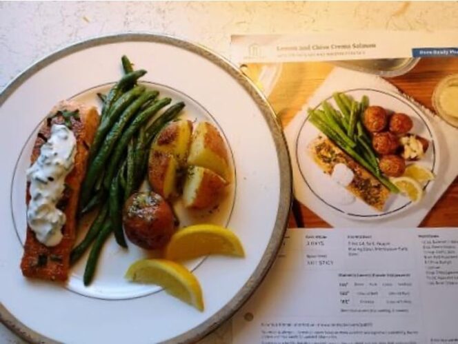 cooked salmon on a plate with creamy sauce and vegetables, next to the recipe card for the dish