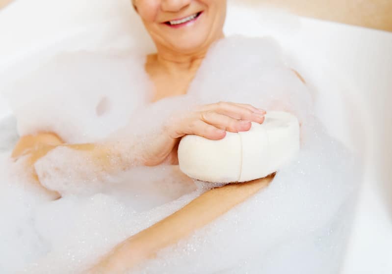 Older adult woman bathes in best walk-in bathtub