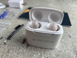 Audien hearing aids in charging case with volume adjusting screwdriver