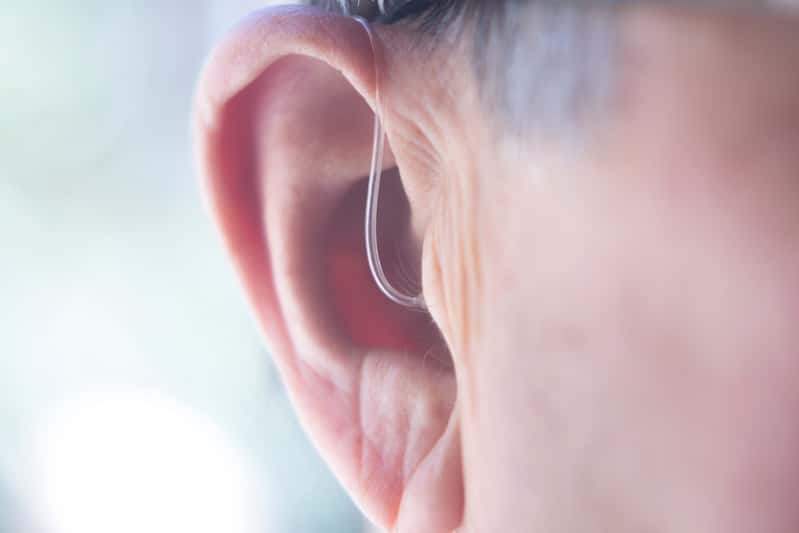 digital hearing aid in man's ear