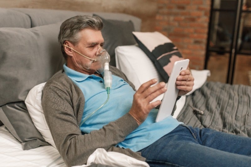 Man using a home oxygen concentrator