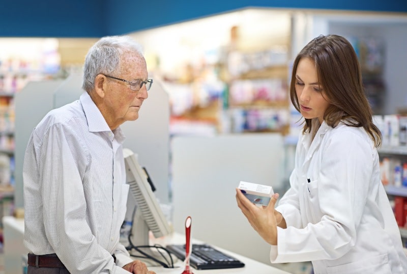 Customer being assisted by a pharmacist at a pharmacy