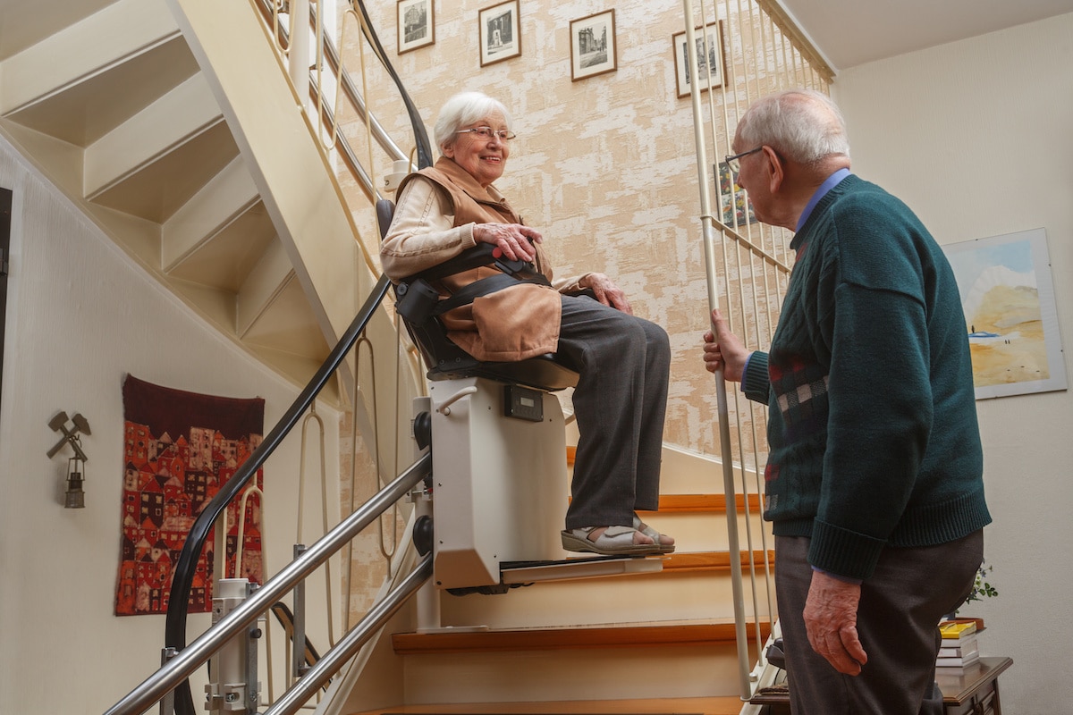 elderly couple at the stairlift at home