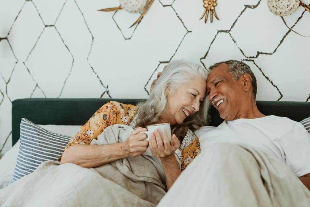 older adult couple in bed at home