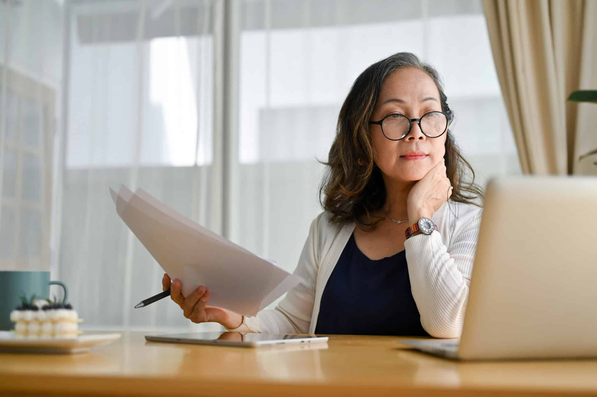 Woman reviewing documents at home