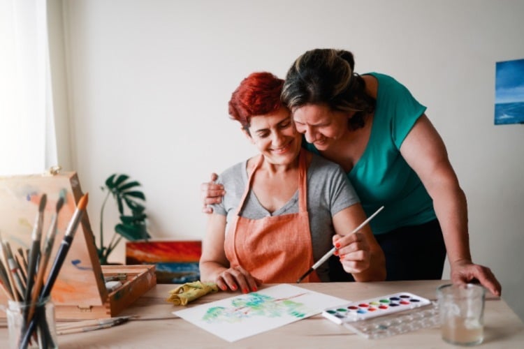 Adults working on watercolor painting together