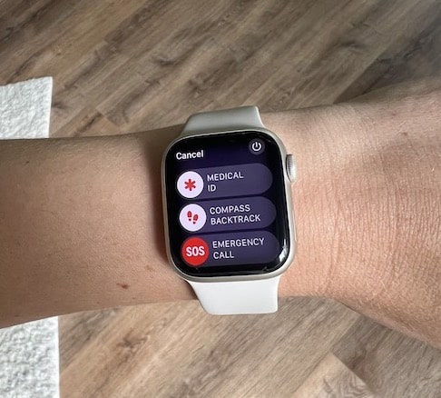 Apple Watch Series 8 on wrist displaying Medical ID, Compass Backtrack, and SOS Emergency Call features