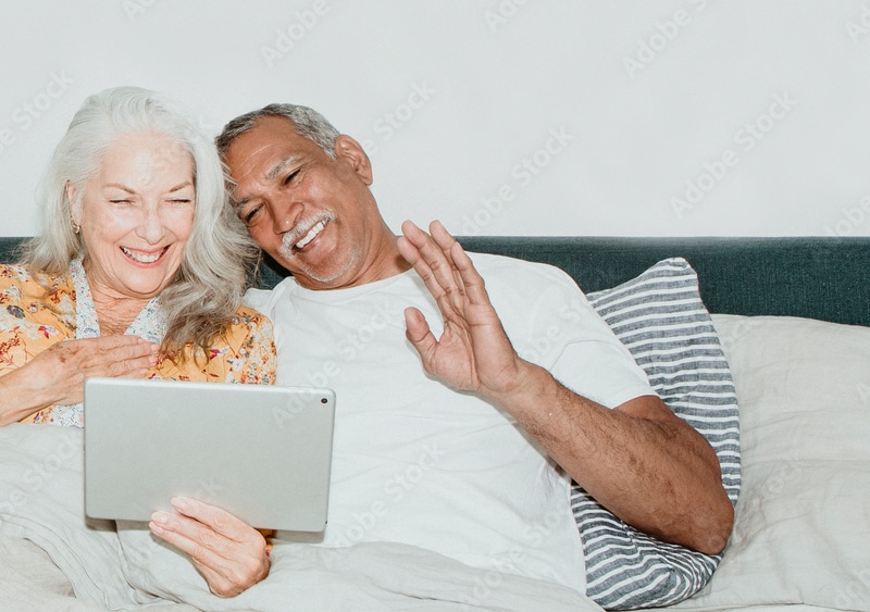 Happy senior couple looking into the iPad