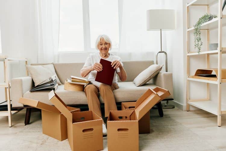 Older adult woman unpacking boxes
