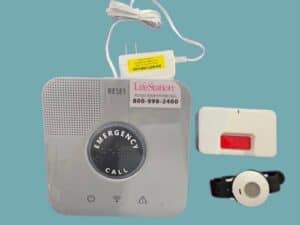  In-home medical alert system, help button bracelet, and wall button against blue background