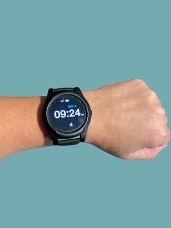Sidekick Smartwatch on wrist with time, date, battery level, and connection strength displayed on the screen.