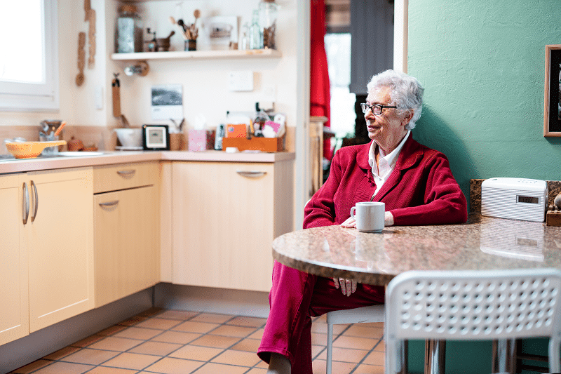 older woman sitting at home