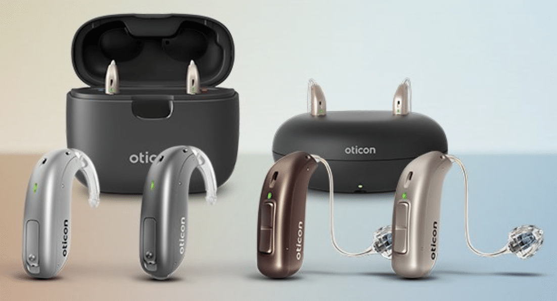 The four models of Oticon Zircon hearing aids with charging cases in the background