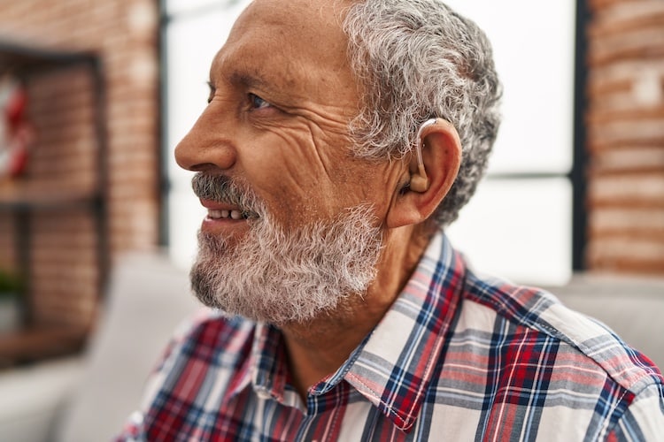Smiling older man wearing hearing aid
