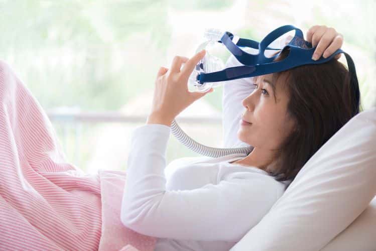 Woman using mask in bed
