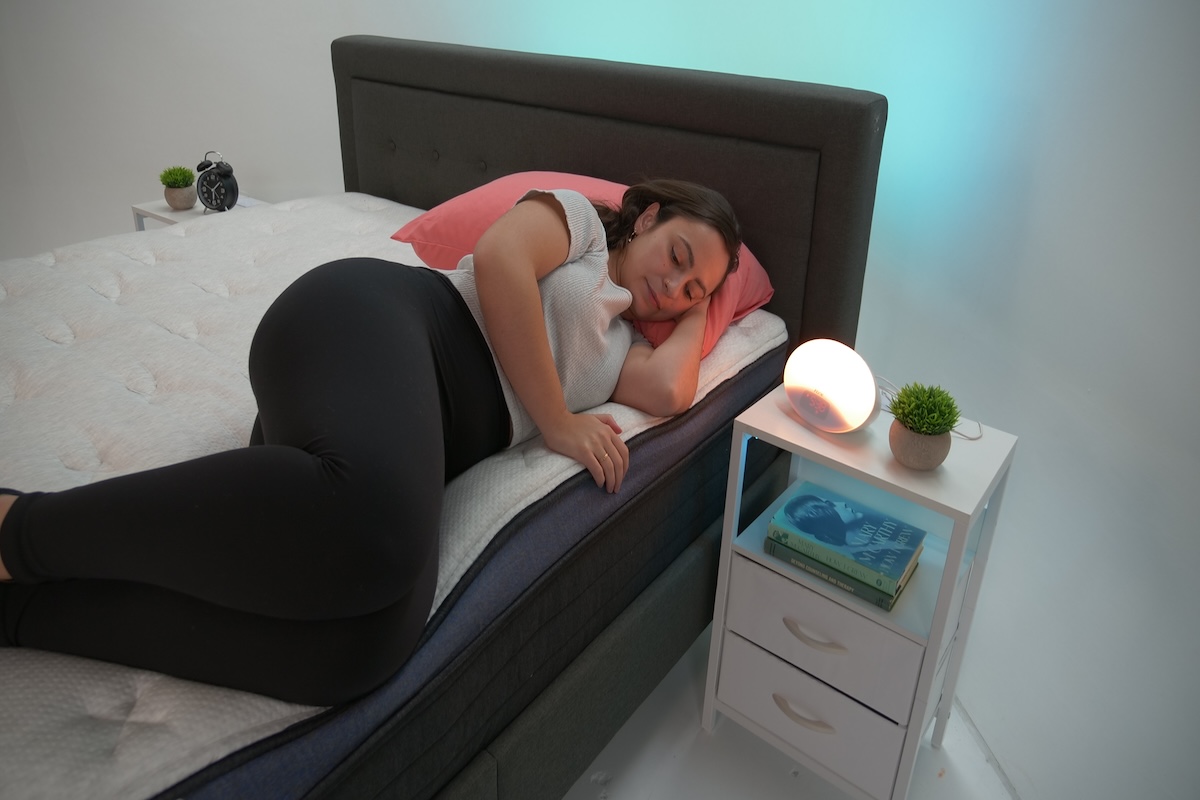 Person lying on the edge of a Helix Midnight Luxe mattress