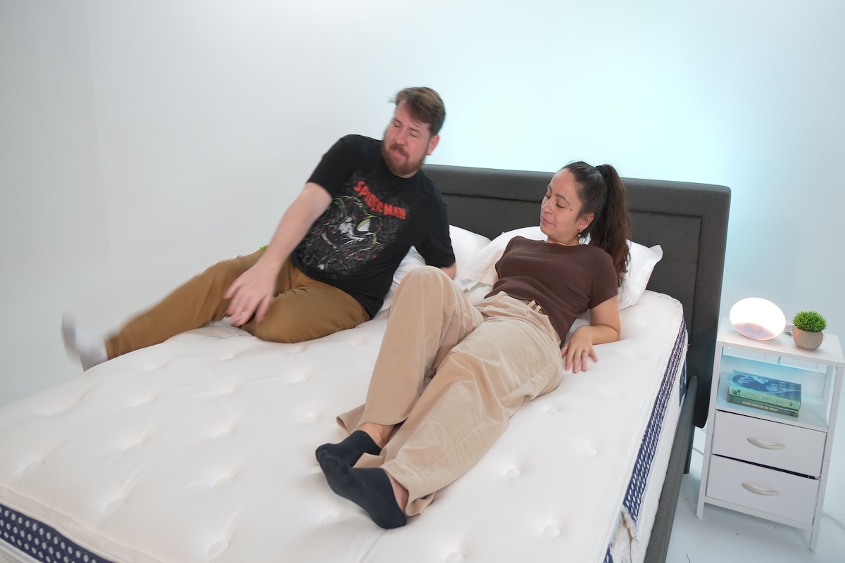 Two people lying on The WinkBed mattress to test motion isolation 