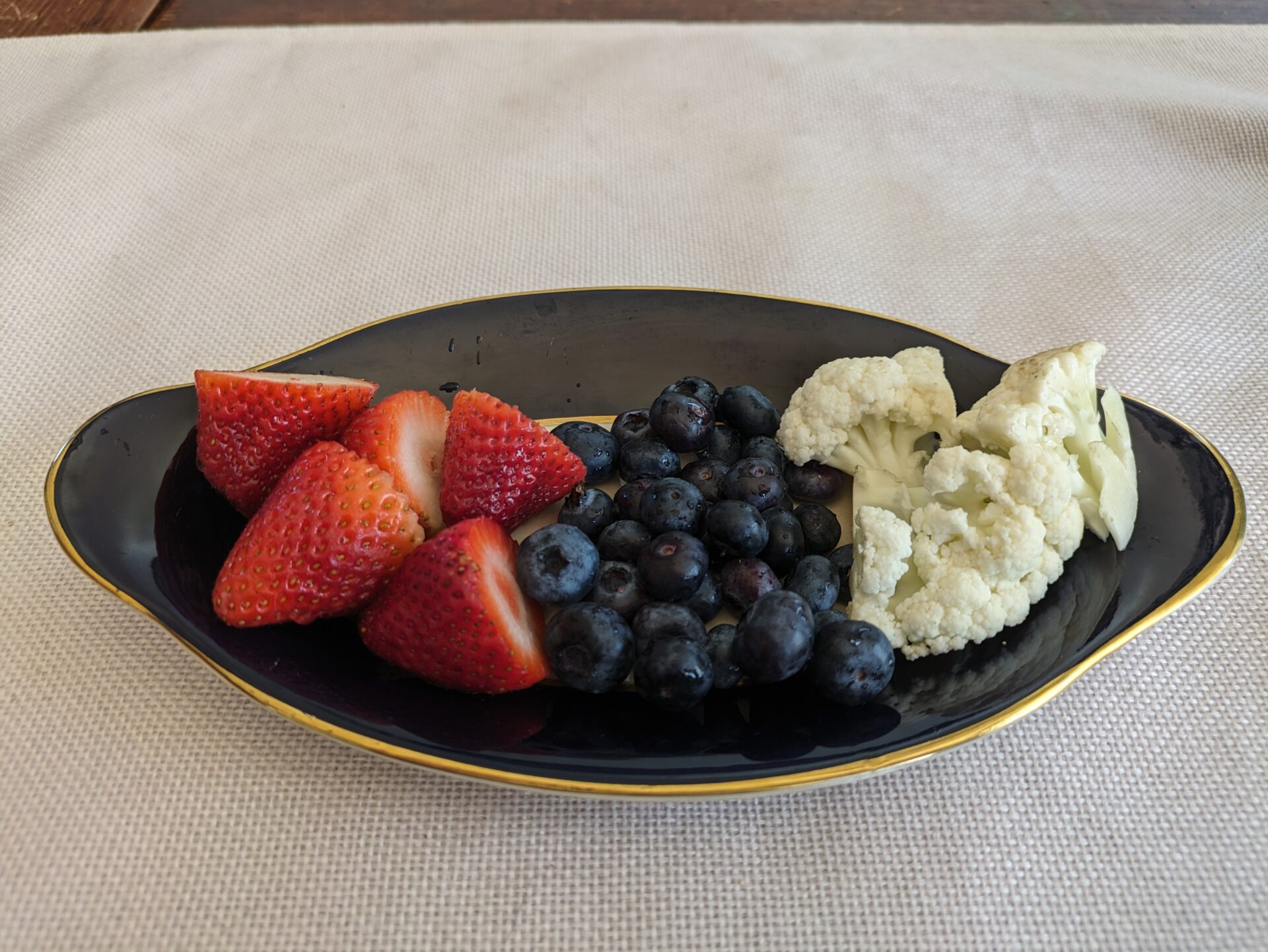 Plate of strawberries, blueberries, and cauliflower