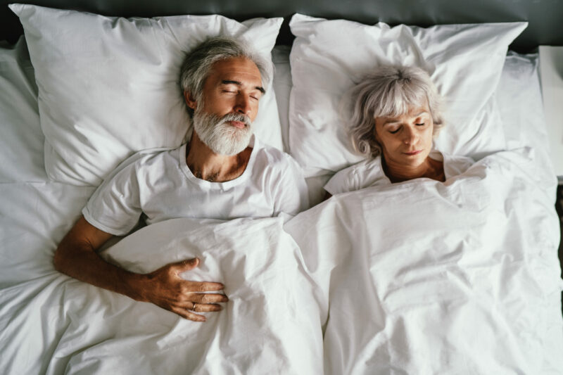 Older couple sleeping on memory foam mattress
