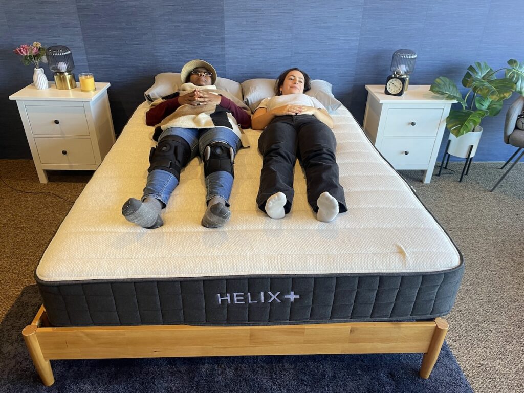 Two people laying on a Helix mattress