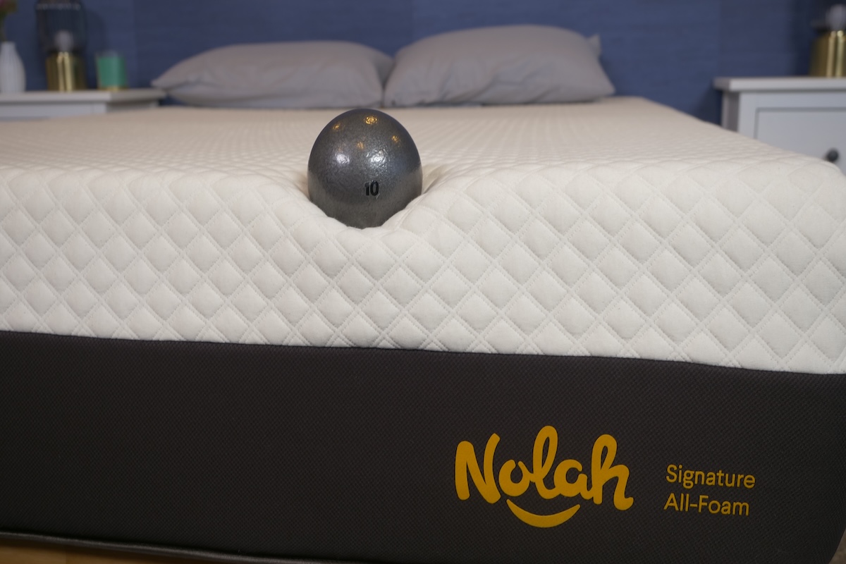 10-pound metal ball rests on top of the Nolah Signature mattress in our testing facility
