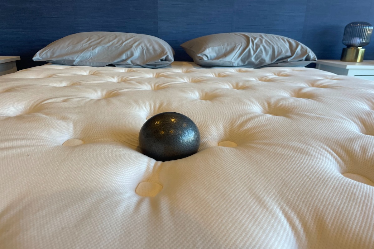 10-pound ball rests in the middle of a WinksBed mattress