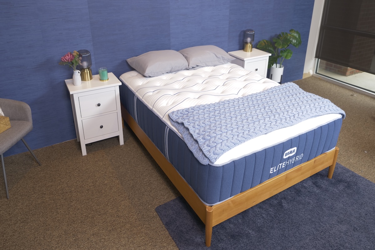  Blue and white Bear Elite Hybrid pillow-top mattress with a blue blanket folded across it