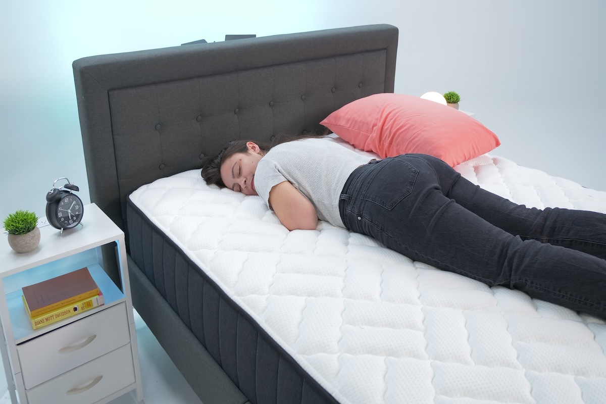 Woman sleeping on her stomach on the Titan Plus mattress