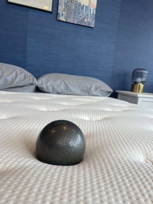 Weighted ball sitting in the middle of the Brooklyn Bedding Signature Hybrid