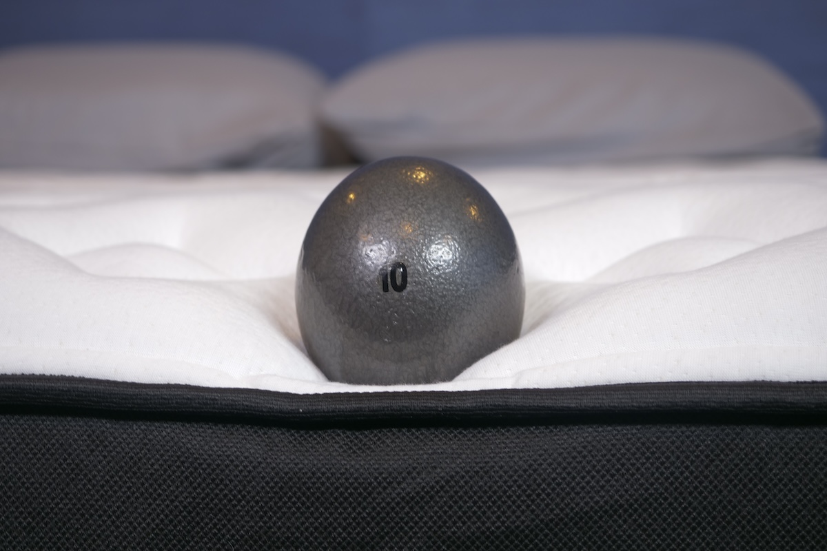  10-pound weighted ball sitting near the edge of the mattress